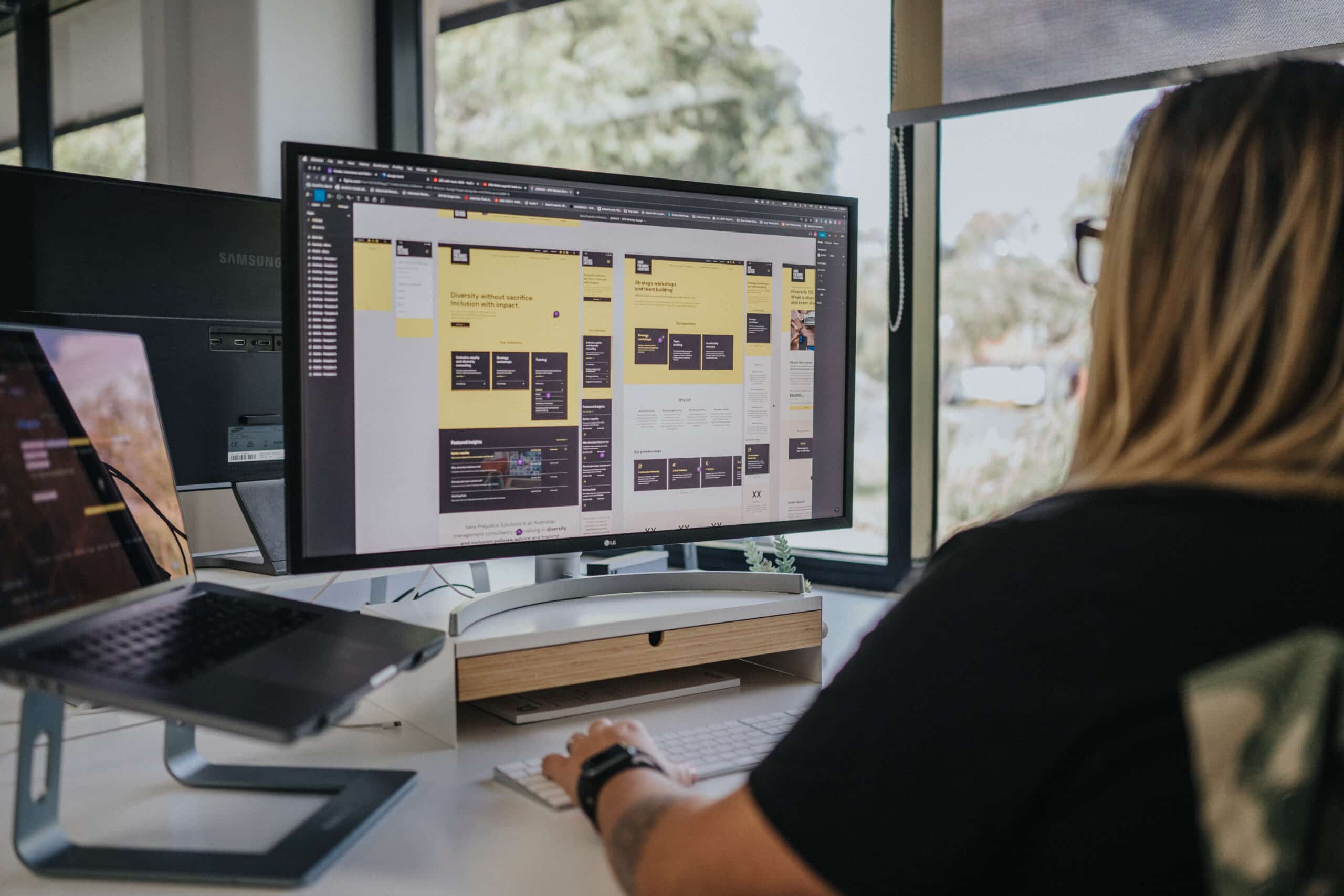 Distl's Senior Designer, Katja, at her desk working on a client's Figma website template