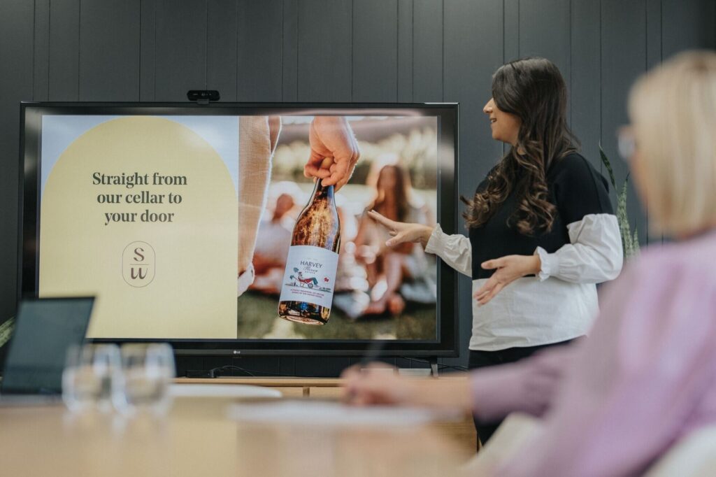 Sarah Brand Account Manager presenting visual identity in boardroom at marketing agency