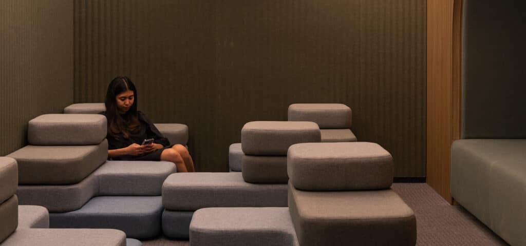 Woman sitting on modern seating arrangement
